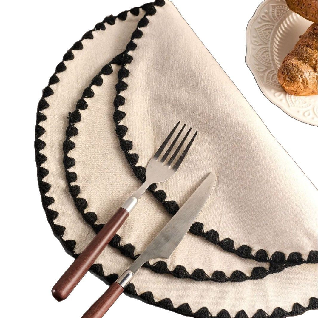 A white napkin with black borders, a fork and a knife on a white background