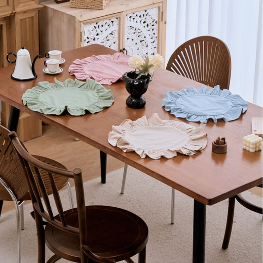 Dining table with decorative plates and chairs in a room setting